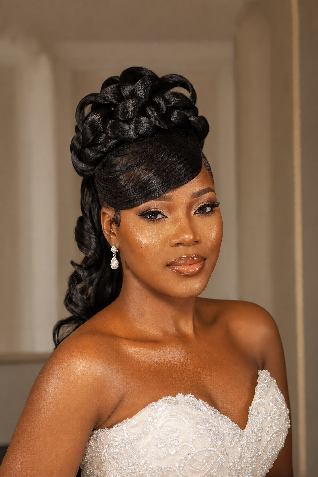 Bridal updo with polished side fringe and braided crown