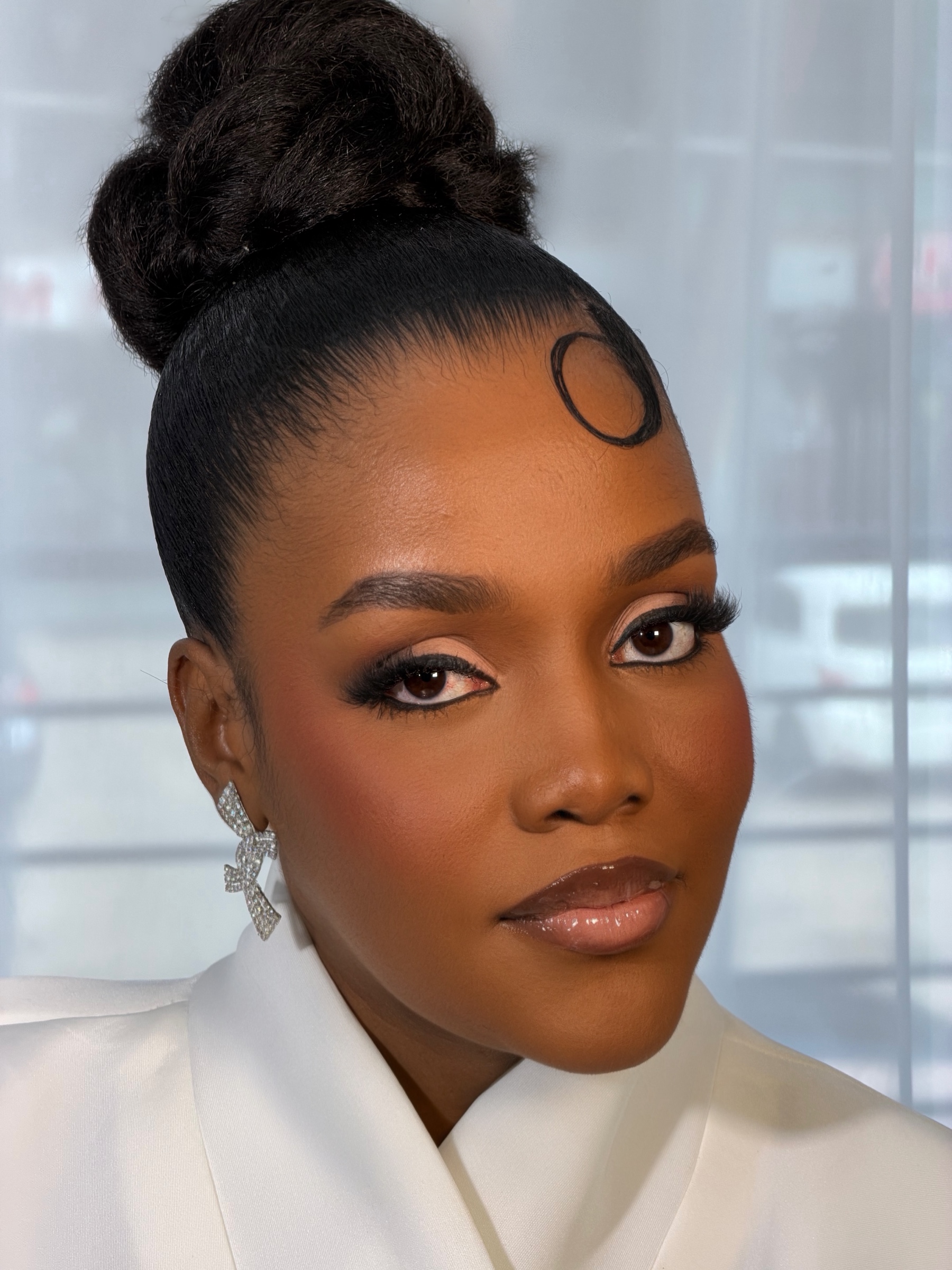 Looped Signature Bun on a Black Ghanaian woman